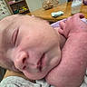 Zoey is registered to the contest to win money with this photo: newborn, baby, sleeping, infant, portrait, close_up, curled_up, hand, fist, skin, blanket, clothing, bottle, wipes, table, toys, alphabet, indoor, nursery, family
