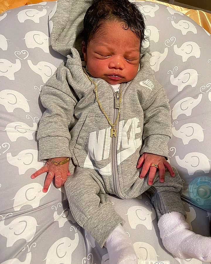 Royce is registered to the contest to win money with this photo: baby, baby_sleeping, baby_toddler_clothing, cheek, child, comfort, cool, facial_expression, hairstyle, happy, head, linens, mouth, nose, pattern, person, sitting, skin, sleeve, textile