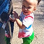 River joined the competition — help win amazing prizes! child, toddler, smiling, standing, outdoor, car, pavement, sunlight, hair_buns, colorful_clothing, shoes, green_pants, white_tshirt, reflection, happy, person, daylight, playful, young_child, cute