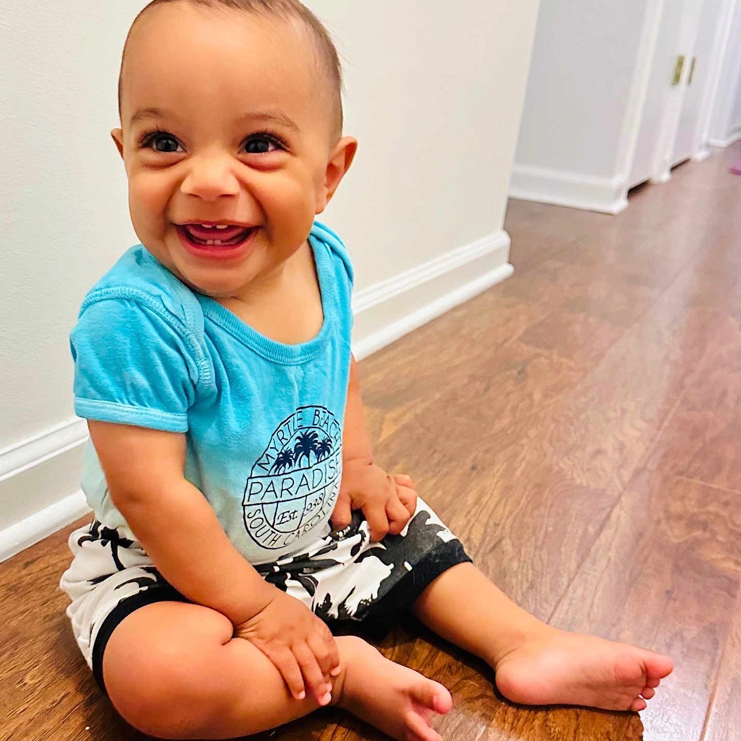Jevon joined the competition — help win amazing prizes! baby, babylaughing, blonde, clothing, face, happy, hardwood, head, jeans, laughing, pants, person, photography, portrait, shorts, sitting, sleeve, smile, t_shirt, wood
