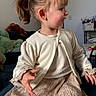 Luna participe au concours pour gagner de l'argent avec cette photo : blonde_hair, cardigan, casual_clothing, child, curious, cute, dress, furniture, girl, home, indoor, person, plush_toys, ponytail, portrait, seated, side_profile, smile, toddler, young_child