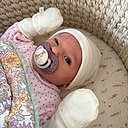 Elie participe au concours pour gagner de l'argent avec cette photo : baby, infant, pacifier, mittens, hat, blanket, floral_pattern, woven_basket, sleepwear, cute, newborn, resting, cozy, pink, white, portrait, indoor, closeup, child, comfort