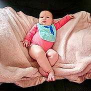 Brooke joined the competition — help win amazing prizes! baby, infant, blanket, pink, bib, clothing, face, foot, hand, relaxed, cute, indoors, soft, comfortable, portrait, child, sitting, couch, furniture, skin