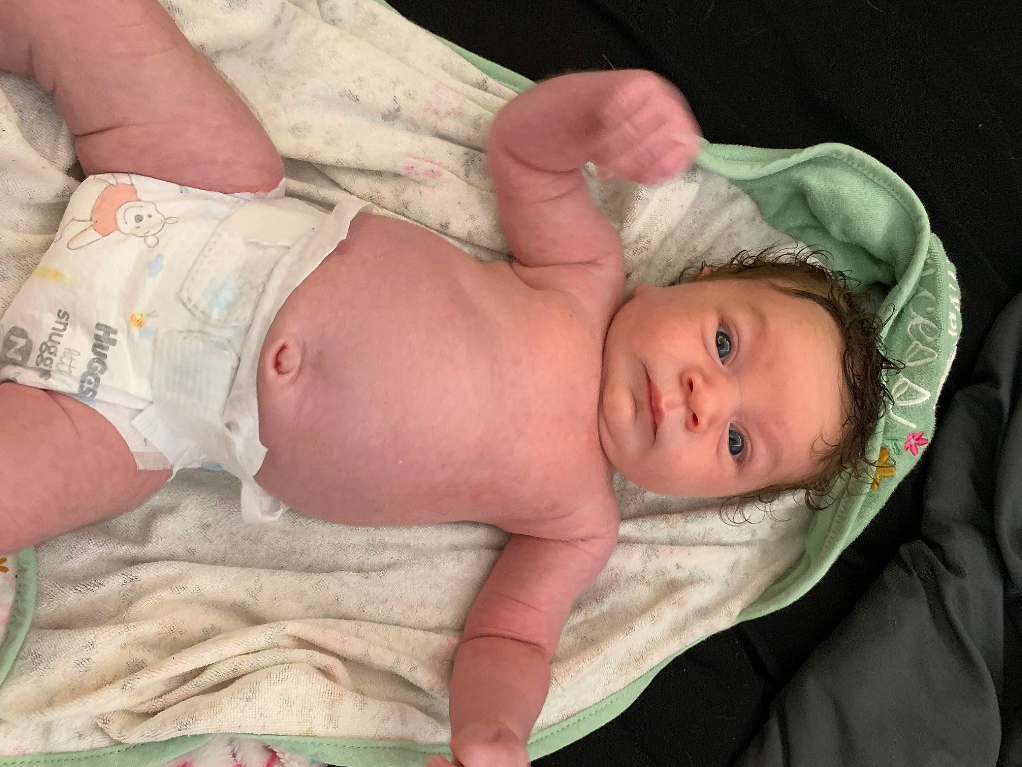 Zaniyah is registered to the contest to win money with this photo: baby, baby_toddler_clothing, cheek, chest, comfort, eye, face, facial_expression, finger, grass, hand, head, human_body, lip, mouth, nose, person, product, skin, stomach