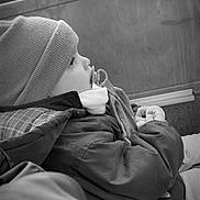 Lyssandro participe au concours pour gagner de l'argent avec cette photo : baby, black_and_white, calm, child, cozy, cute, face, hat, indoor, jacket, looking_out, pacifier, portrait, scarf, seated, side_view, soft_light, warm_clothing, window, winter