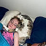 child, sleeping, cat, bed, blanket, pillow, indoor, rest, cozy, cute, pet, fur, snuggle, comfort, relaxation, closed_eyes, freckles, blue_blanket, pink_shirt, wall