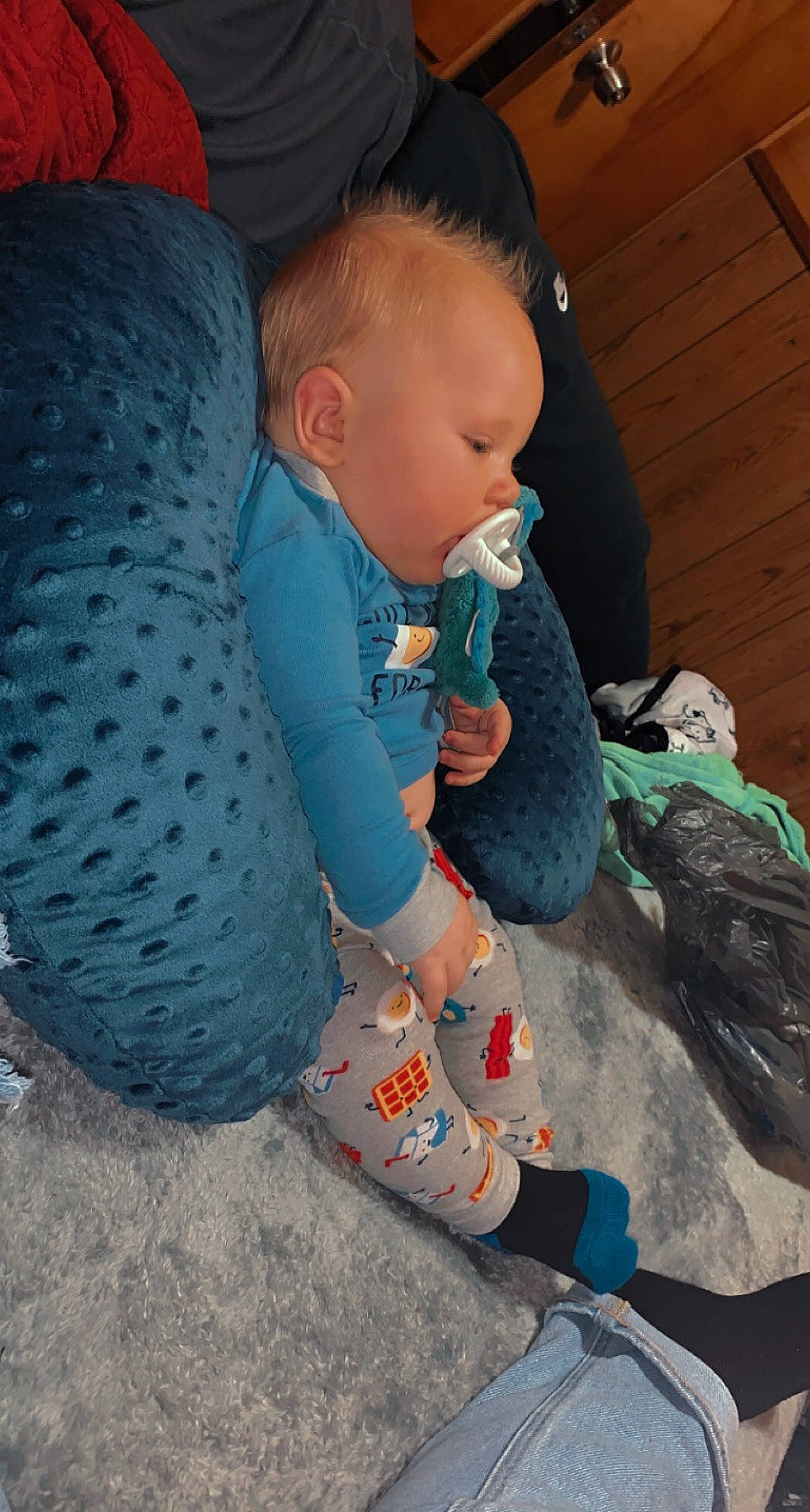 Haiden is registered to the contest to win money with this photo: baby, baby_products, baby_toddler_clothing, child, comfort, cool, electric_blue, flooring, fun, grass, human_leg, lap, leg, outerwear, pattern, person, play, sitting, sleeve, sock