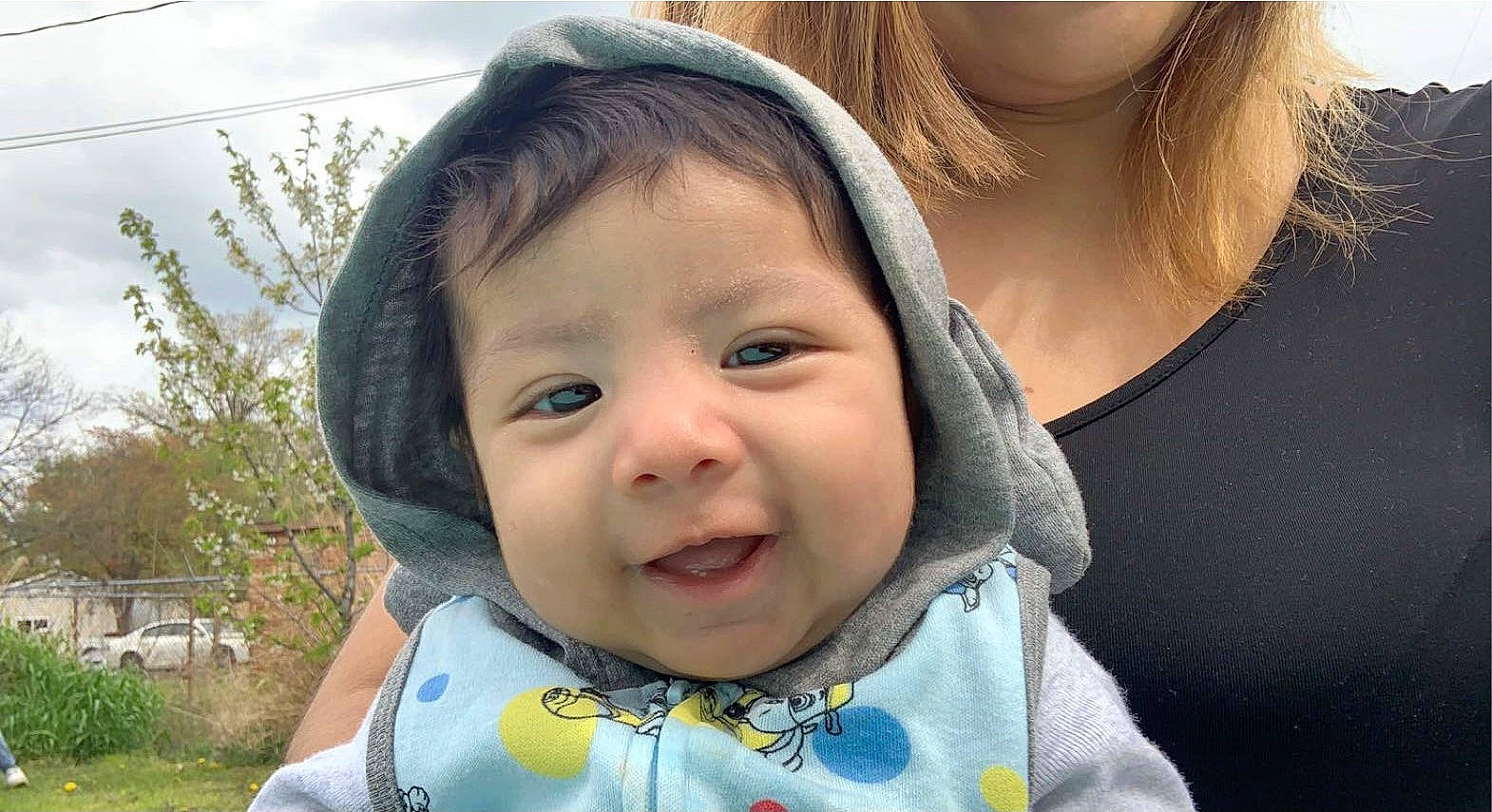 Jacob is registered to the contest to win money with this photo: baby, baby_toddler_clothing, cheek, chin, ear, eyebrow, eyelash, facial_expression, happy, iris, jaw, lip, mouth, nose, outerwear, person, plant, skin, sleeve, smile