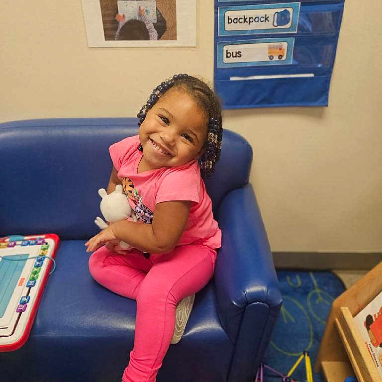 Aria is registered to the contest to win money with this photo: ball, chair, child, clothing, couch, face, female, football, footwear, furniture, girl, head, person, photography, portrait, shoe, sitting, soccer, soccerball, sport