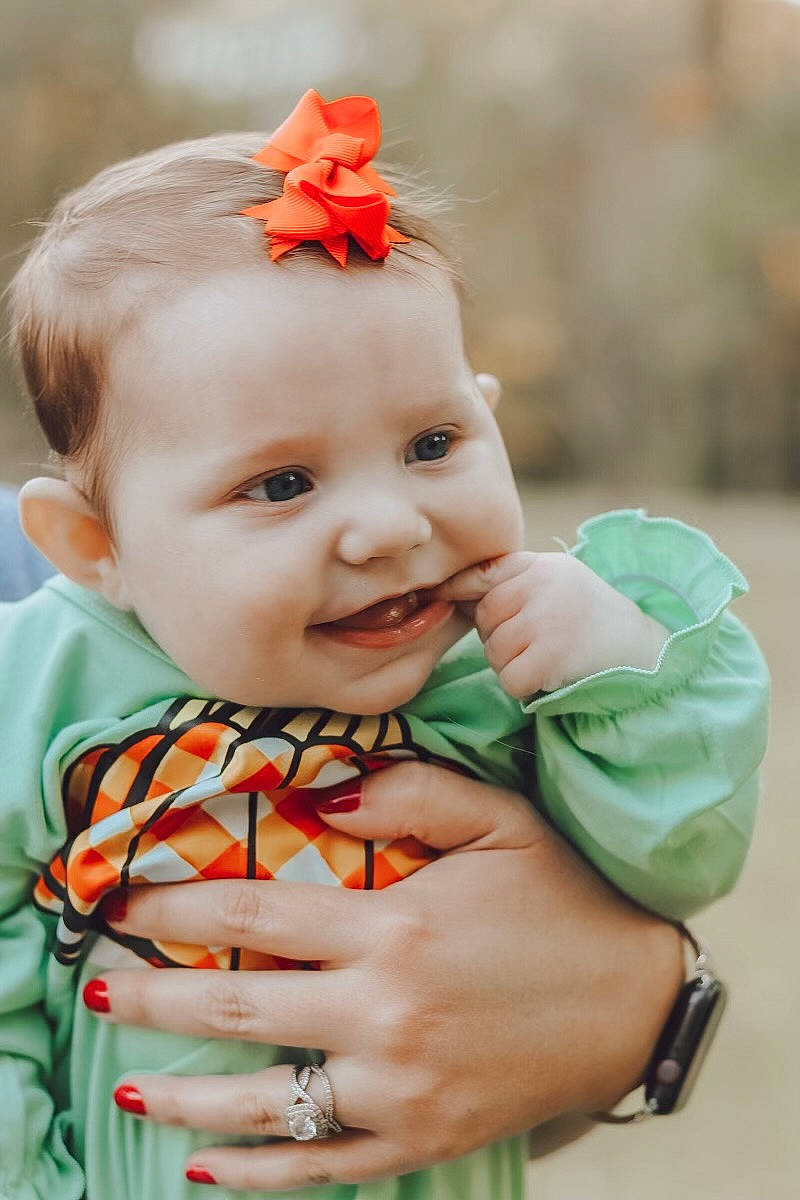 Oaklynne joined the competition — help win amazing prizes! baby, baby_toddler_clothing, child, chin, dress, eye, grass, hair, hand, happy, iris, joy, lip, orange, pattern, people_in_nature, person, plant, skin, sleeve