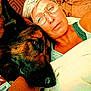 arm, blanket, casual_clothing, close_up, comfort, companion, couch, dog, face, german_shepherd, glasses, head, home, indoor, person, pet, relaxed, resting, short_hair, snuggling