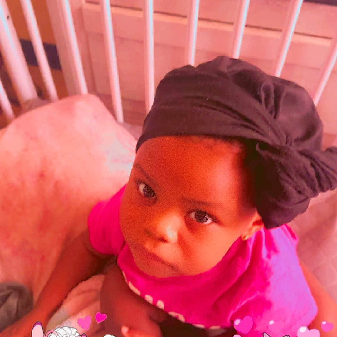 Amberlee is registered to the contest to win money with this photo: accessories, baby, bed, bonnet, cap, clothing, crib, earring, face, furniture, hat, head, indoors, infantbed, jewelry, nursery, person, photography, portrait, room