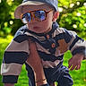 Mathias a rejoint le concours — aidez-le/la à gagner de superbes lots ! baby, child, sunglasses, cap, striped_clothing, blue_clothing, outdoor, greenery, hand, person, cute, sunlight, portrait, toddler, fashion, accessory, holding, casual, infant, nature