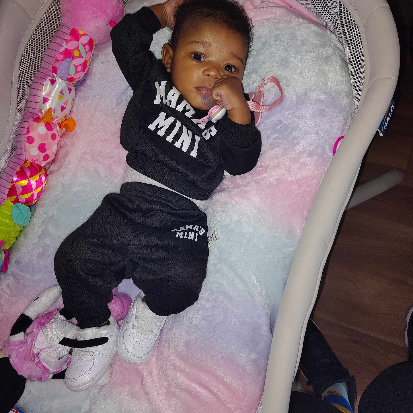 Jae'Onie joined the competition — help win amazing prizes! baby, baby_outfit, bassinet, black_clothing, blanket, child, cute, floor, home, indoor, infant, pacifier, person, pink, purple, relaxing, soft_toy, toy, white, white_shoes