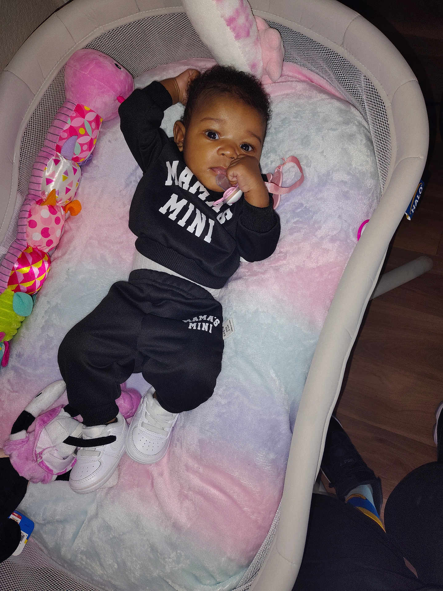 Jae'Onie joined the competition — help win amazing prizes! baby, baby_outfit, bassinet, black_clothing, blanket, child, cute, floor, home, indoor, infant, pacifier, person, pink, purple, relaxing, soft_toy, toy, white, white_shoes