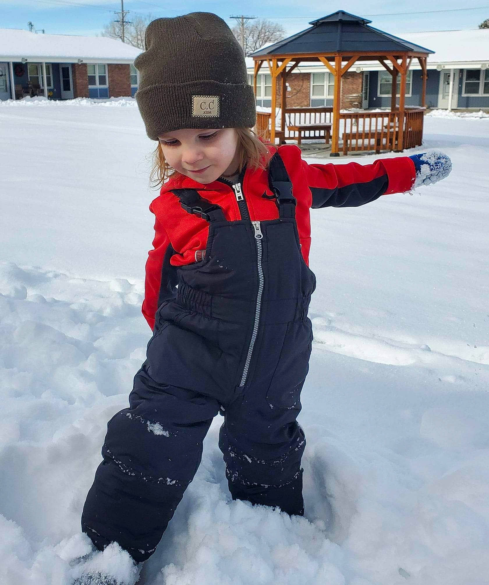Asher is registered to the contest to win money with this photo: baby_toddler_clothing, building, cap, child, cloud, electric_blue, freezing, fun, headwear, ice_cap, jacket, knit_cap, person, recreation, sky, sleeve, slope, smile, snow, toddler