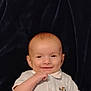 Jaxon joined the competition — help win amazing prizes! baby, smiling, infant, child, white_shirt, collar, hand, face, head, skin, lying_down, blanket, dark_background, portrait, cute, happy, young, person, indoors, closeup