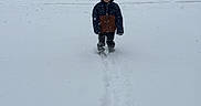 Noah James is registered to the contest to win money with this photo: child, snow, winter, hooded_jacket, footprints, forest, trees, snowfall, outdoor, cold, nature, person, young, clothing, walking, season, scenery, daylight, landscape, weather