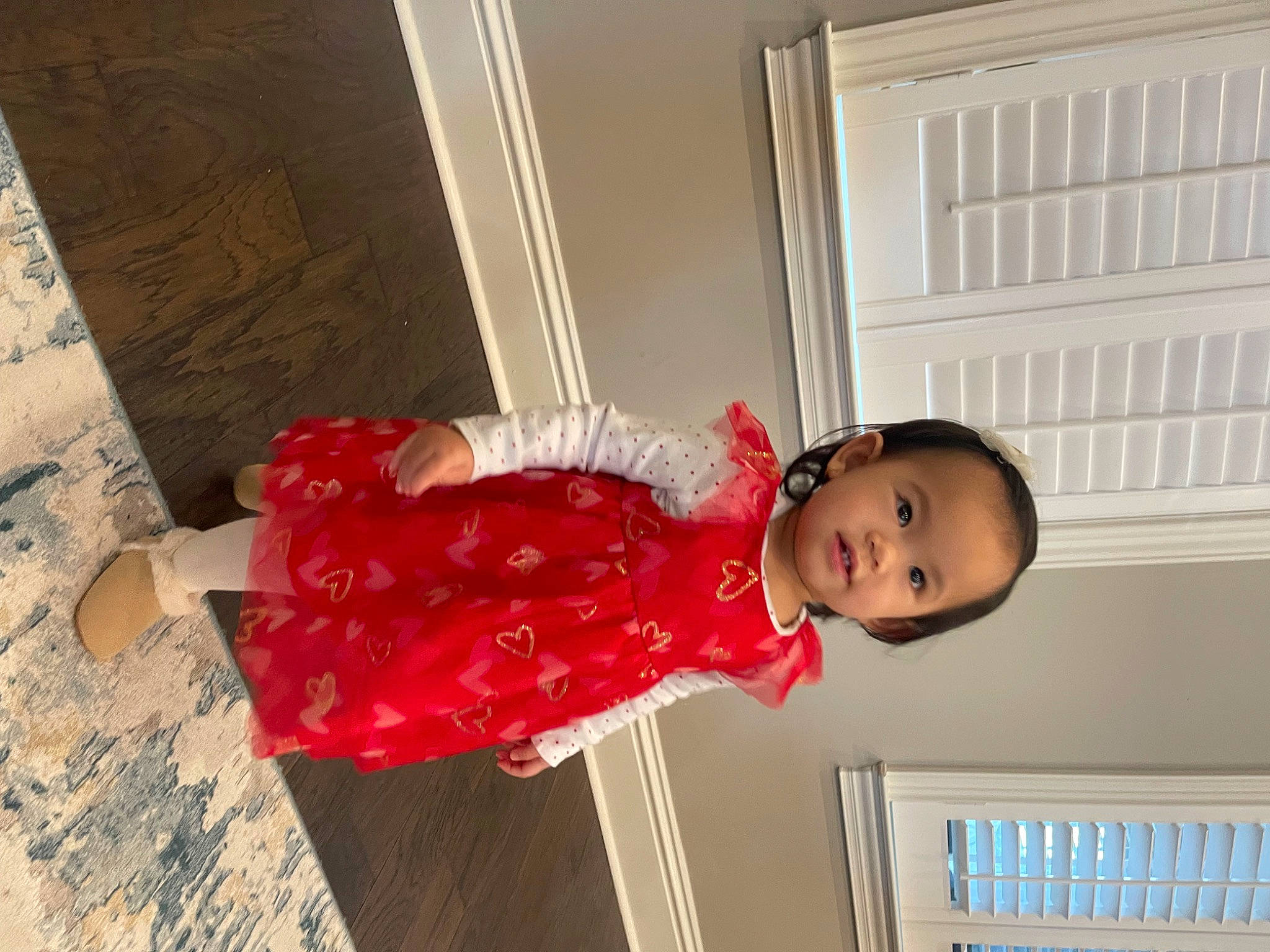 Ella is registered to the contest to win money with this photo: baby, baby_toddler_clothing, child, door, flooring, happy, hardwood, magenta, pattern, person, room, sleeve, smile, toddler, window, wood