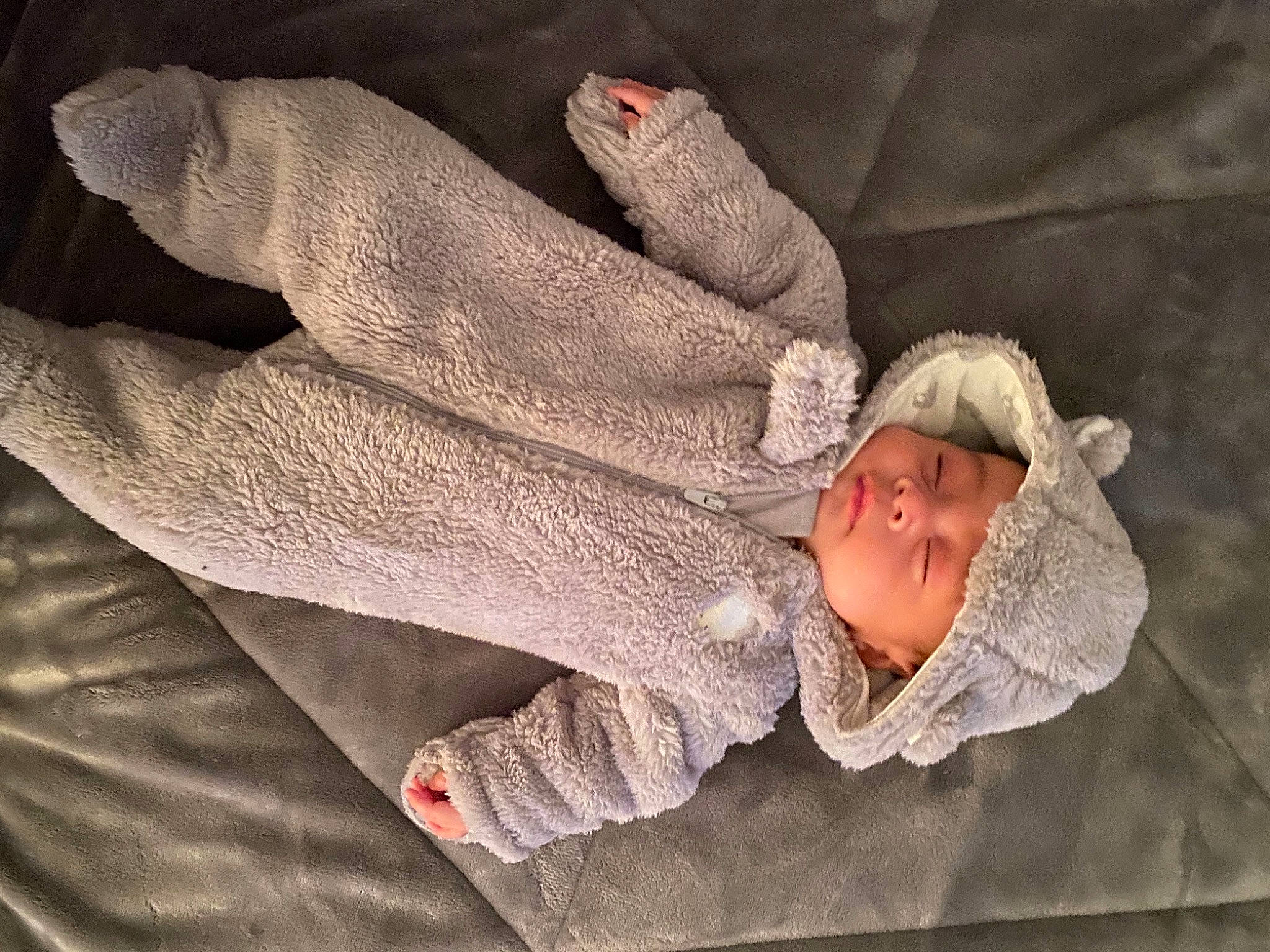 Khalani is registered to the contest to win money with this photo: baby, baby_toddler_clothing, bonnet, comfort, flesh, gesture, headwear, hood, nail, person, safety_glove, skin, textile, wool, woolen