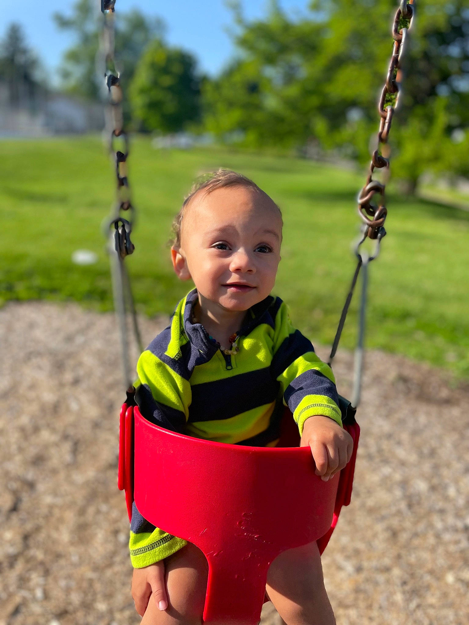 Rayden is registered to the contest to win money with this photo: baby, baby_toddler_clothing, black, fun, grass, happy, head, leisure, people_in_nature, person, photograph, plant, playground, sleeve, smile, summer, swing, toddler, tree, white