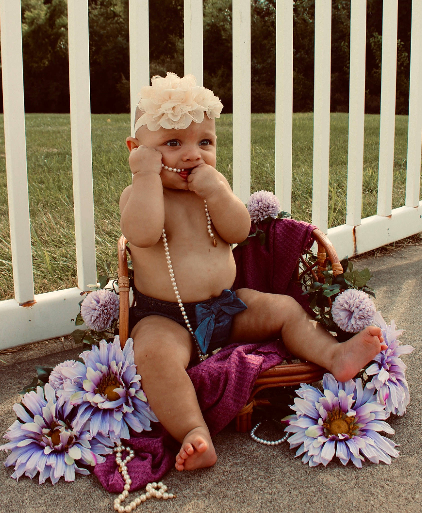 Zamiri is registered to the contest to win money with this photo: barefoot, event, fence, floral_design, flower, flower_arranging, grass, happy, hat, headgear, headpiece, headwear, human_leg, jewellery, people, person, petal, pink, plant, sitting