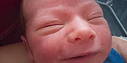 Ismail participe au concours pour gagner de l'argent avec cette photo : newborn, baby, smile, face, closeup, infant, person, skin, clothing, blue, white, head, sleeping, resting, arm, indoors, human, cute, happy, portrait