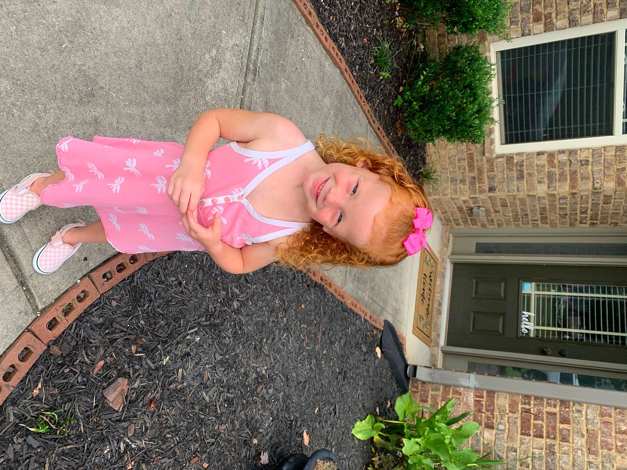 Haisley is registered to the contest to win money with this photo: abdomen, dress, foot, fun, garden, grass, human_leg, joy, leisure, magenta, people_in_nature, person, pink, plant, sandal, sidewalk, sitting, soil, thigh, waist