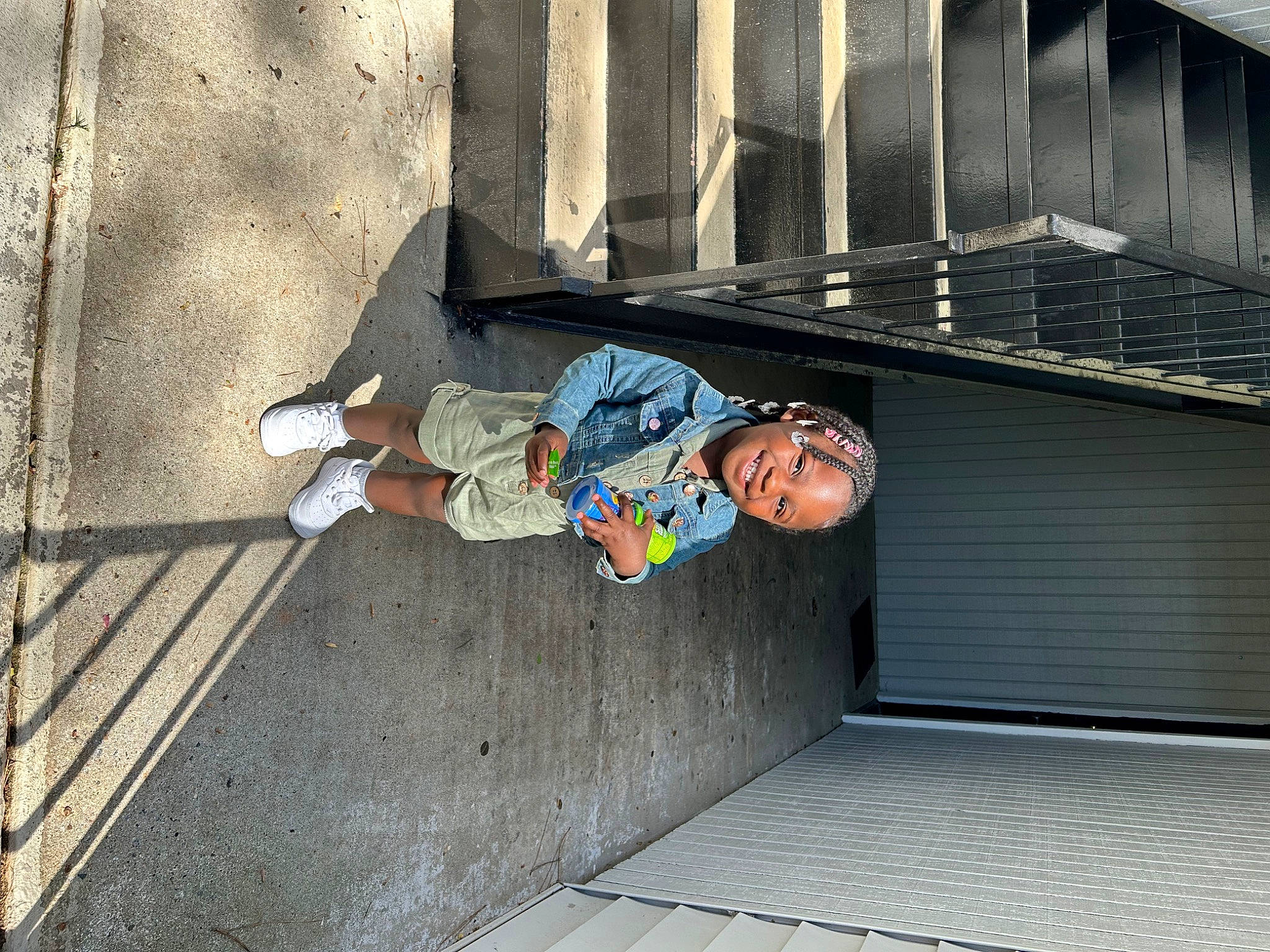 Malaya joined the competition — help win amazing prizes! asphalt, child, city, composite_material, concrete, flooring, fun, human_leg, joy, leisure, person, recreation, road_surface, shadow, sidewalk, sitting, street, t_shirt, toddler, tree