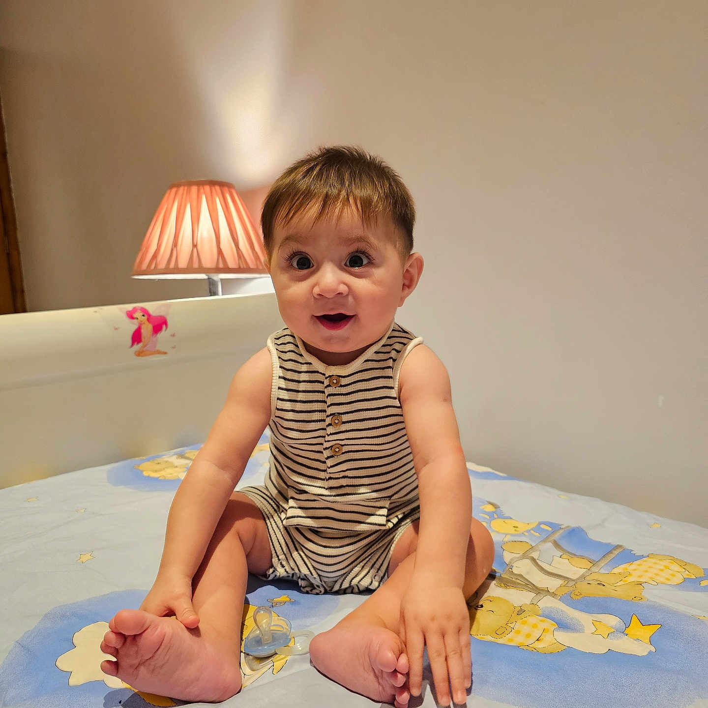 Jahan joined the competition — help win amazing prizes! baby, bed, bedroom, child, cute, foot, furniture, hand, happy, indoors, infant, lamp, pacifier, person, room, sitting, smiling, stars, striped_clothing, teddy_bear