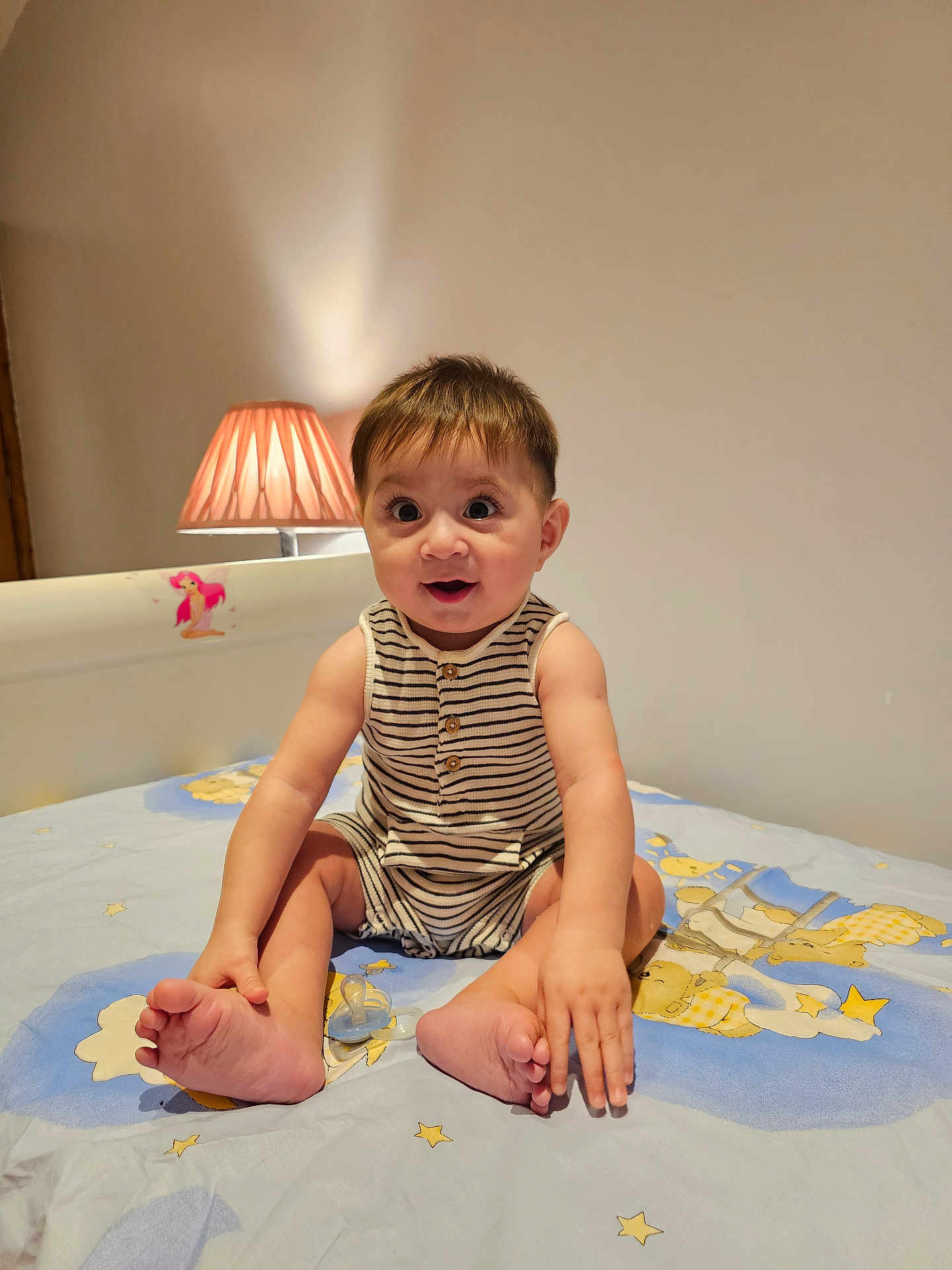 Jahan joined the competition — help win amazing prizes! baby, bed, bedroom, child, cute, foot, furniture, hand, happy, indoors, infant, lamp, pacifier, person, room, sitting, smiling, stars, striped_clothing, teddy_bear
