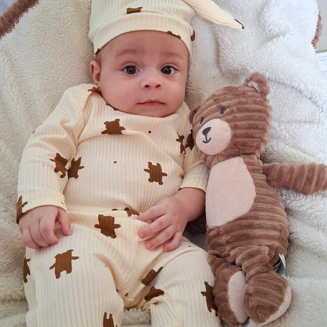 Lonnie joined the competition — help win amazing prizes! baby, bed, blanket, calm, child, comfort, cozy, cute, face, hat, indoors, infant, lying_down, pajamas, portrait, sleepwear, soft_toy, stuffed_animal, teddy_bear, toddler