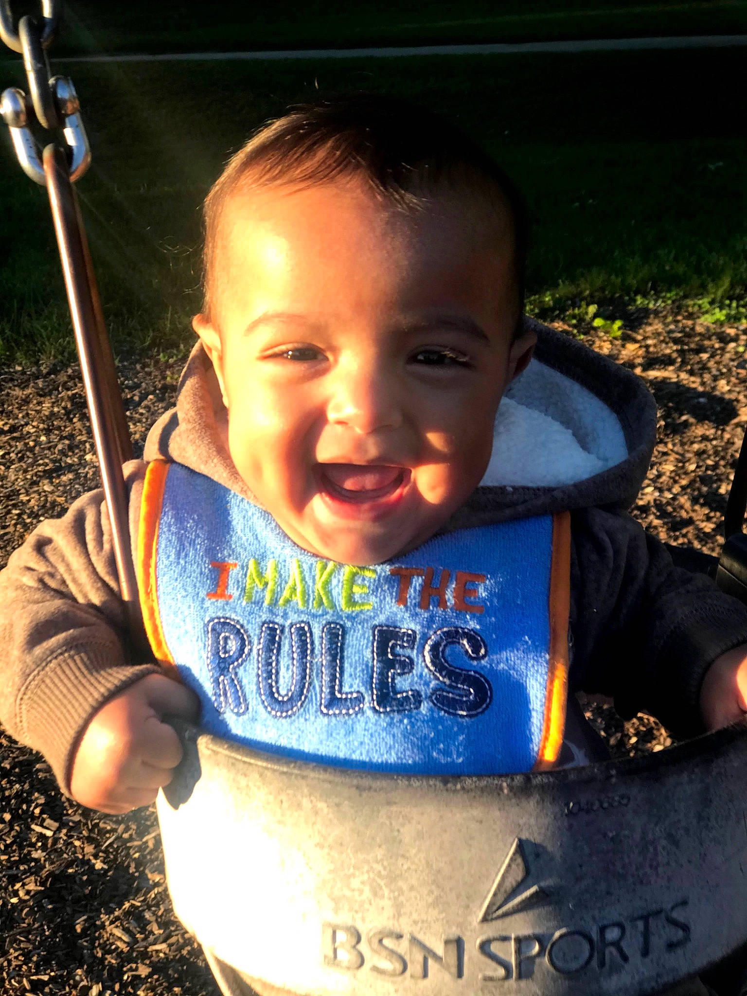 Amias is registered to the contest to win money with this photo: baby, baby_toddler_clothing, caesar_cut, child, cool, happy, laugh, mouth, outdoor_play_equipment, person, play, swing, toddler, tooth