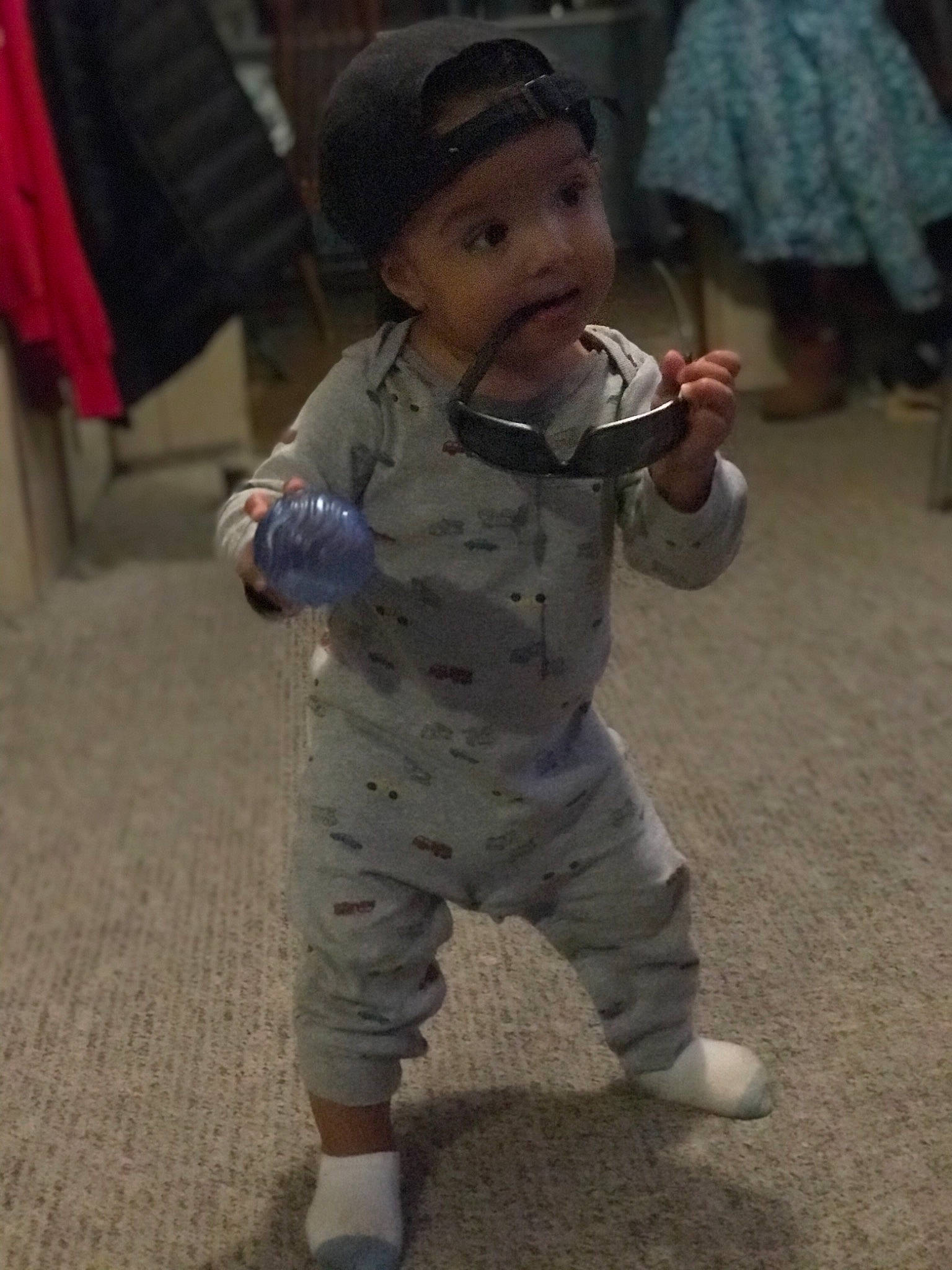 Amias is registered to the contest to win money with this photo: baby, baby_toddler_clothing, bonnet, camouflage, child, headwear, human_body, joint, nightwear, one_piece_garment, pajamas, person, sleeve, standing, toddler