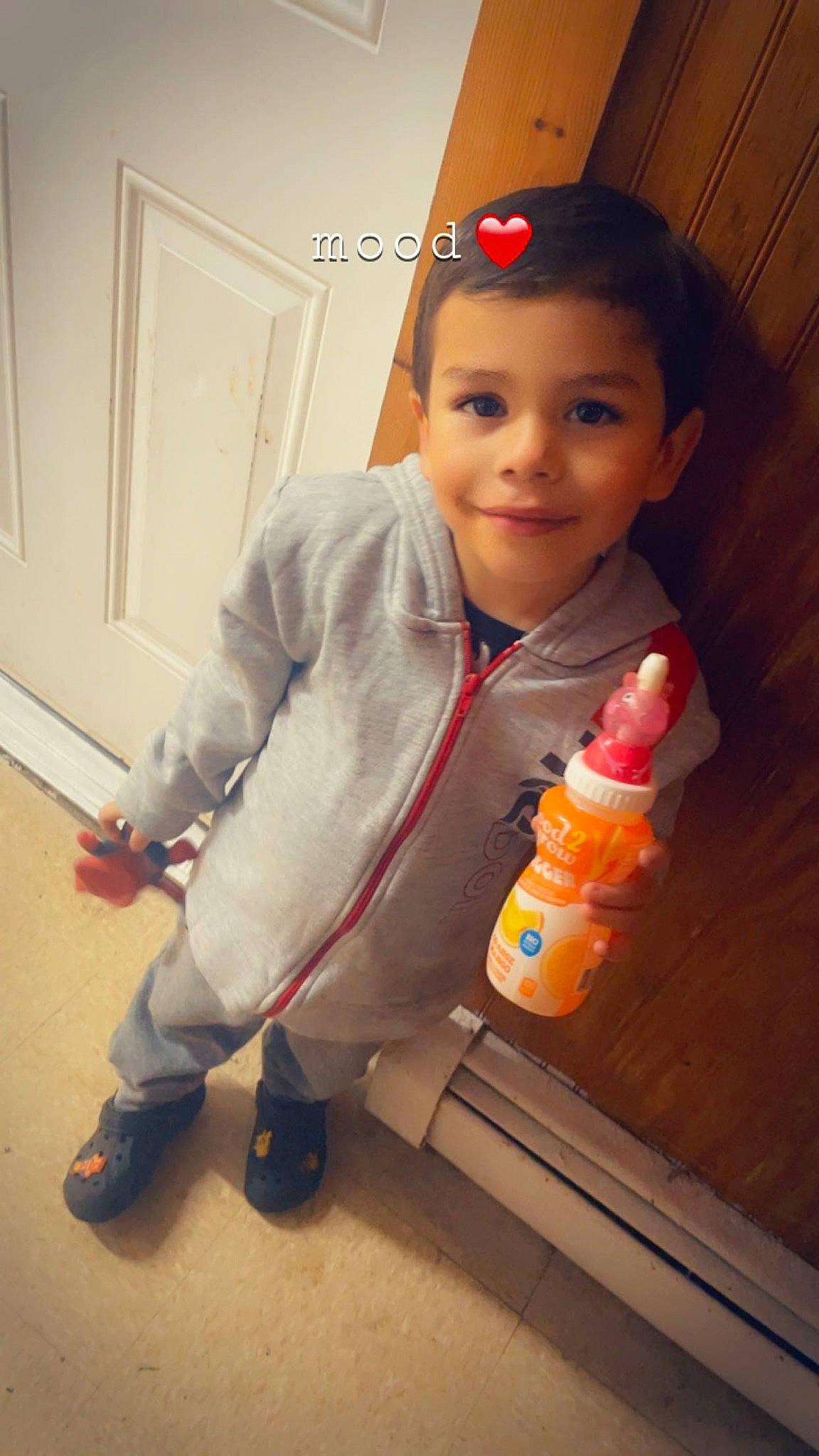 Josiah joined the competition — help win amazing prizes! baby, baby_bottle, bottle, bottle_cap, cap, child, door, drink, drinkware, finger, flooring, fun, joy, person, plastic_bottle, skin, smile, standing, thumb, toddler