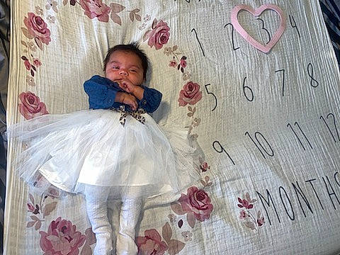 Leilani joined the competition — help win amazing prizes! baby_toddler_clothing, beauty, child, day_dress, dress, embellishment, face, facial_expression, fashion_design, happy, linens, magenta, pattern, person, pink, product, skin, sleeve, standing, textile