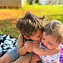 Paisley is registered to the contest to win money with this photo: child, baby, toddler, outdoor, grass, blanket, kiss, affection, holding_hands, cute, siblings, summer, sunlight, happy, nature, playtime, casual_clothing, barefoot, love, family