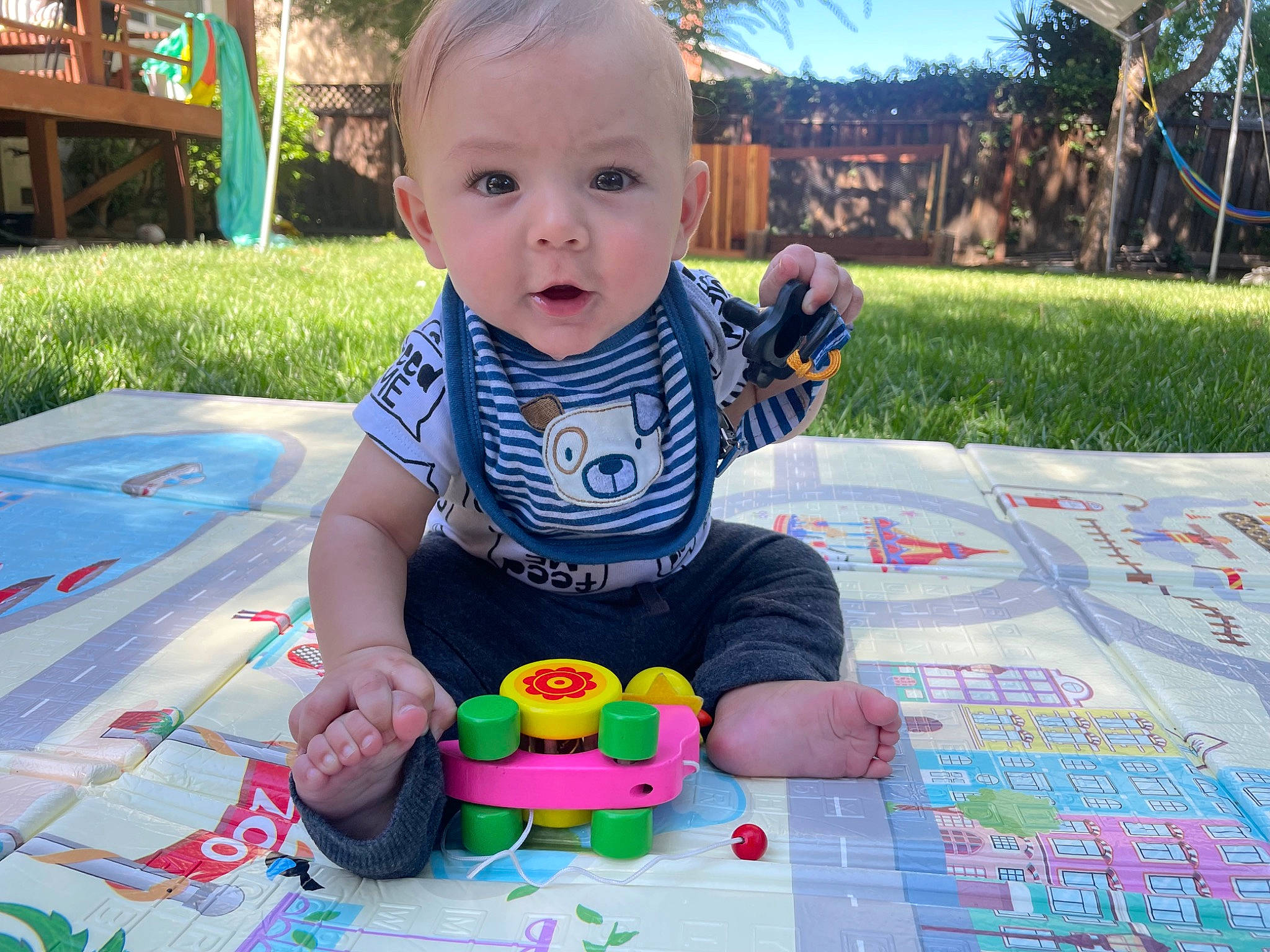 Tomás joined the competition — help win amazing prizes! baby, baby_playing_with_toys, baby_toddler_clothing, child, flooring, fun, grass, happy, leisure, pattern, person, plant, play, recreation, sitting, sky, smile, toddler, toy, tree
