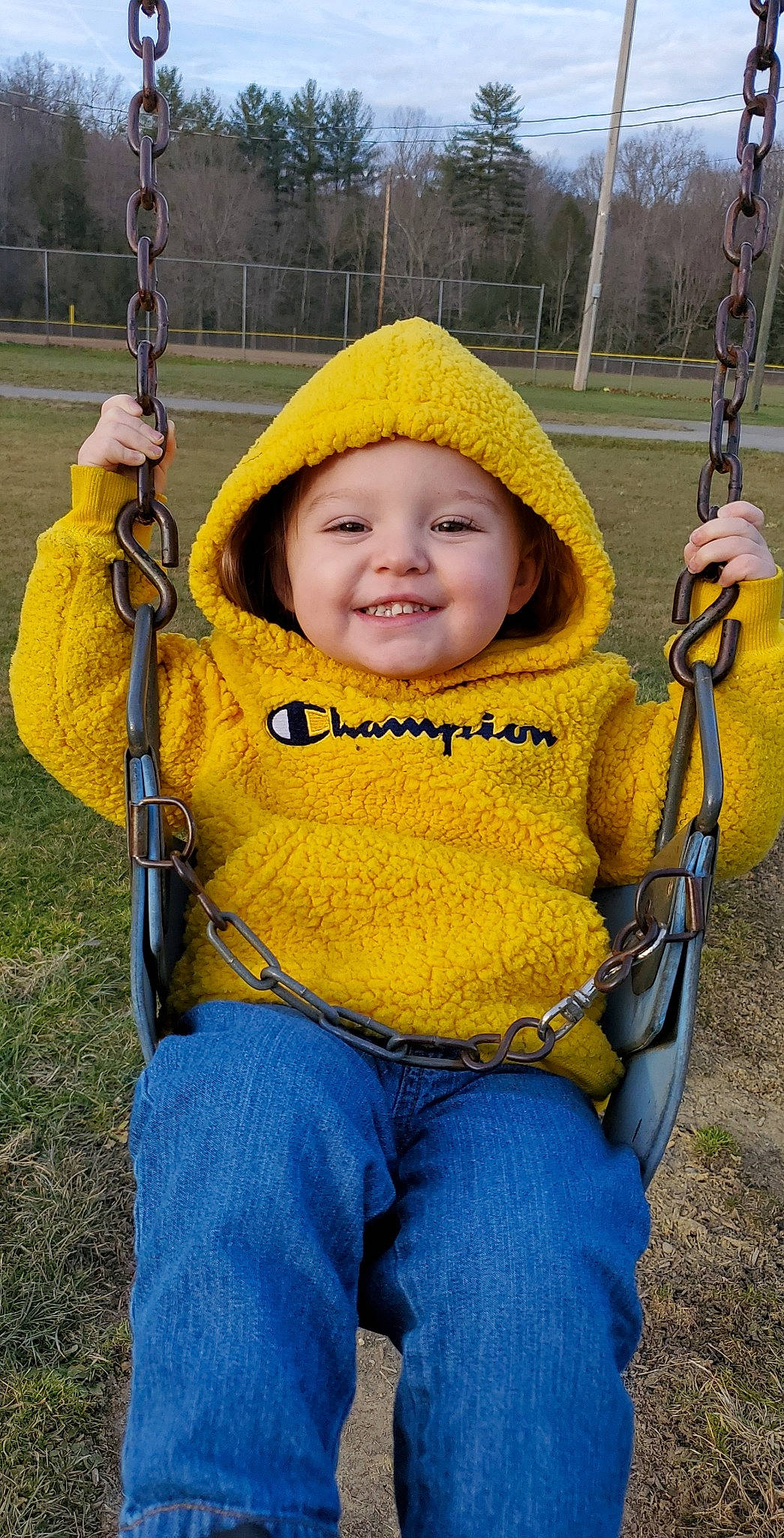 Anthony is registered to the contest to win money with this photo: baby, facial_expression, fun, grass, green, happy, headwear, jeans, joy, leaf, organ, people_in_nature, person, photograph, plant, product, skin, smile, swing, toddler