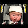 Armani joined the competition — help win amazing prizes! baby, child, car_seat, hat, infant, face, straps, warning_label, seatbelt, clothing, portrait, closeup, young_child, expression, headwear, indoor, person, safety, seat, young_baby