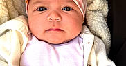 Armani joined the competition — help win amazing prizes! baby, infant, headband, bow, cardigan, blanket, portrait, face, hands, clothing, closeup, indoors, child, cute, soft_texture, photo_gallery, mobile_screen, user_interface, button, edit
