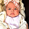 baby, infant, headband, bow, cardigan, blanket, portrait, face, hands, clothing, closeup, indoors, child, cute, soft_texture, photo_gallery, mobile_screen, user_interface, button, edit