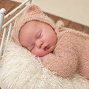 Blakely is registered to the contest to win money with this photo: newborn, baby, sleeping, portrait, closeup, face, bonnet, blanket, wrapped, pink, fluffy, cream, crib, basket, indoor, cozy, peaceful, infant, wooden_floor, photography