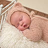 newborn, baby, sleeping, portrait, closeup, face, bonnet, blanket, wrapped, pink, fluffy, cream, crib, basket, indoor, cozy, peaceful, infant, wooden_floor, photography