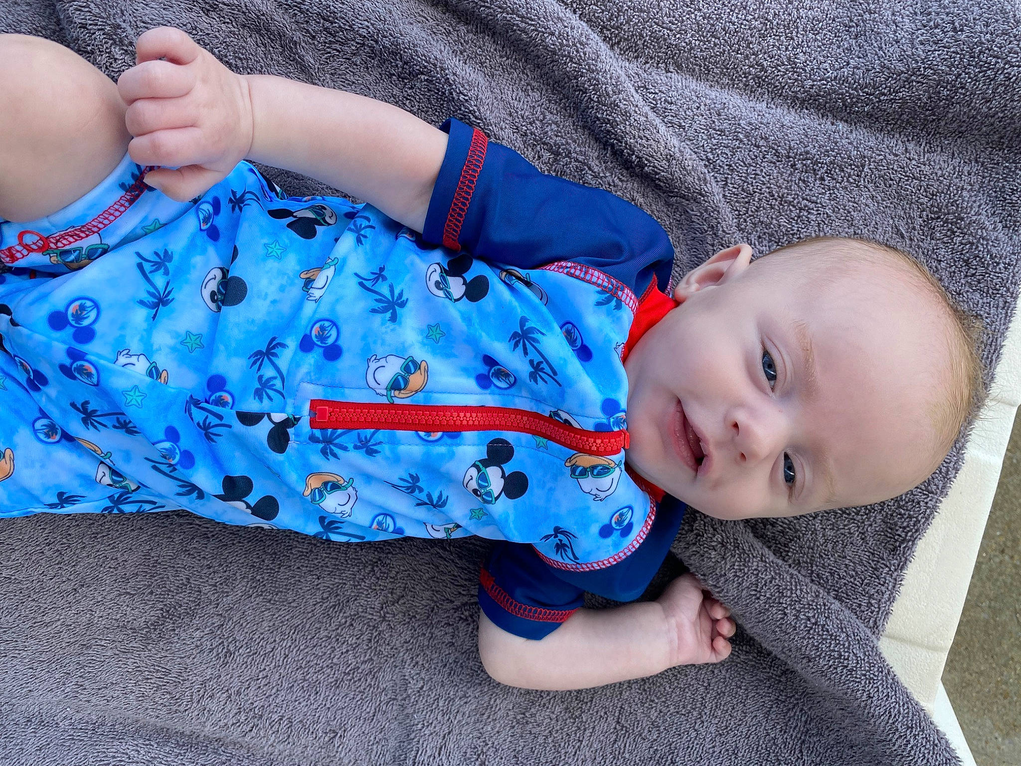 Raylan is registered to the contest to win money with this photo: azure, baby, baby_products, baby_toddler_clothing, blue, cheek, child, comfort, electric_blue, eye, hairstyle, hand, head, mouth, nose, pattern, person, sitting, skin, sleeve