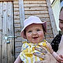 baby, child, smile, hat, pink, yellow, dress, tattoo, hand, person, outdoor, wood, shed, door, sunlight, happy, portrait, cute, holding, face