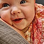 baby, close_up, smiling, face, headband, pink, blue_eyes, infant, cute, child, portrait, soft, fabric, clothing, pattern, colorful, happy, skin, cheeks, snuggle