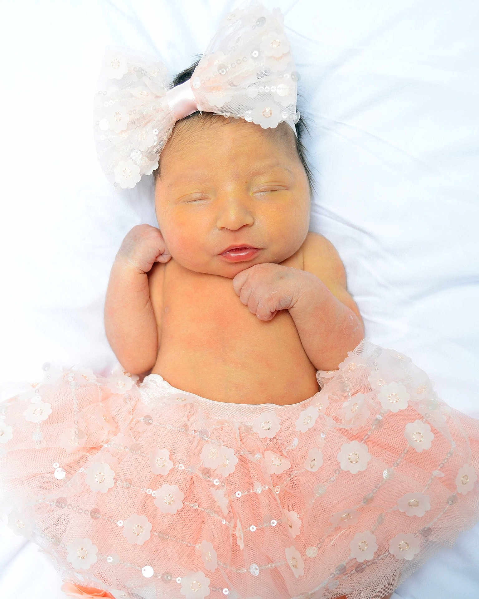 Evelyn is registered to the contest to win money with this photo: baby, bed, bodypart, bonnet, clothing, dress, face, fashion, finger, formalwear, furniture, gown, hand, hat, head, newborn, person, photography, portrait, sleeping