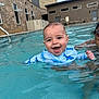 baby, child, pool, water, swimming, smiling, happy, person, adult, building, stone_wall, swim_shirt, blue, outdoor, summer, splashing, face, fun, leisure, sunlight