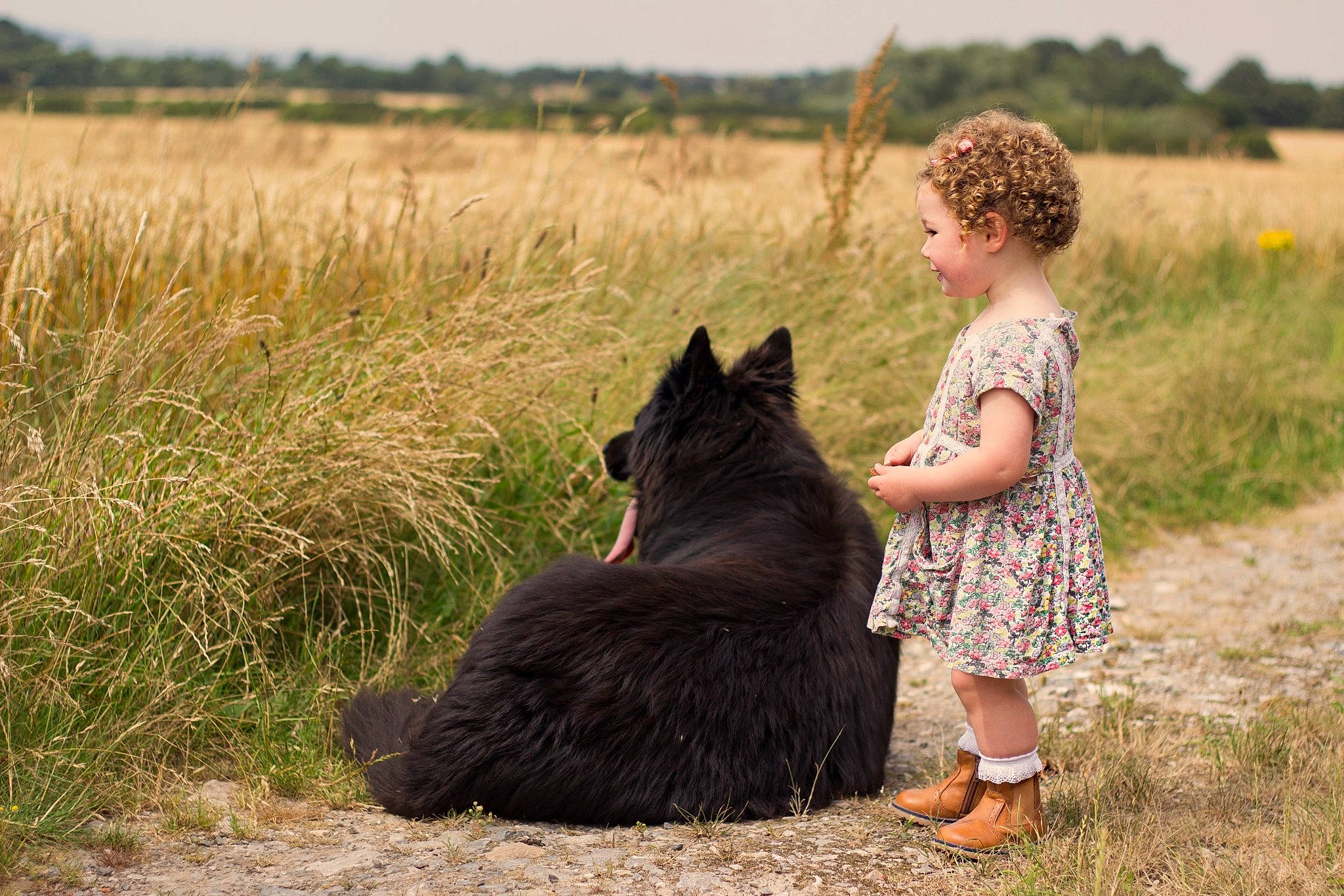 Darcie joined the competition — help win amazing prizes! carnivore, dog_breed, fun, grass, grassland, happy, landscape, leisure, people_in_nature, person, plant, prairie, recreation, sandal, sky, sporting_group, terrestrial_animal, toddler, tree, vertebrate